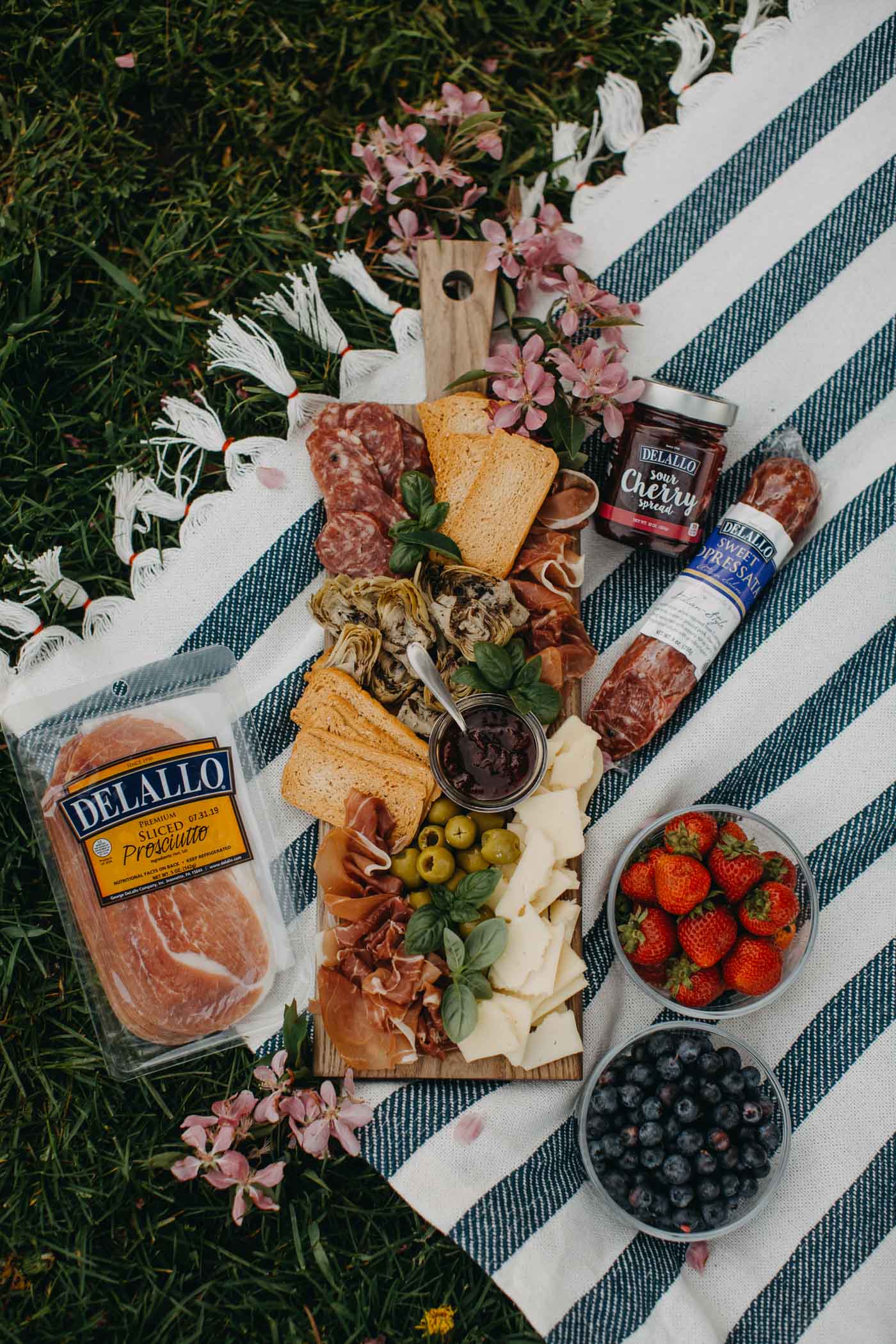 Artisan charcuterie board with wine and fresh fruit for a winery picnic