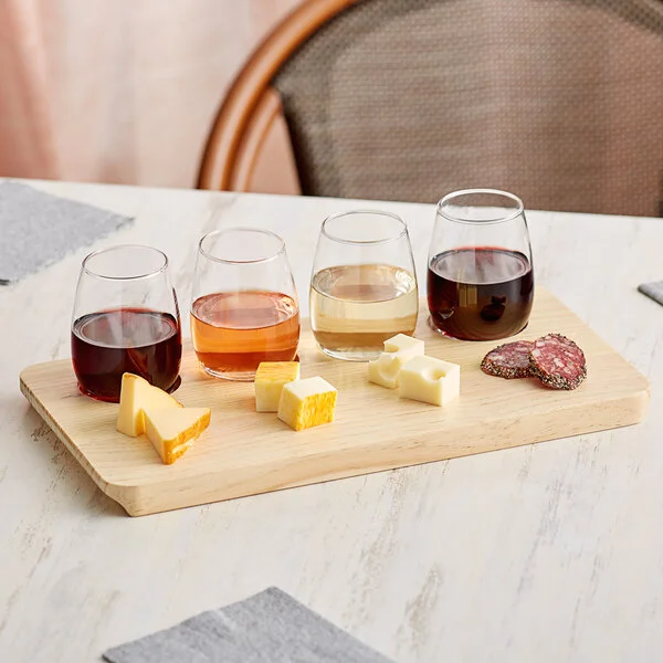Wine tasting flight board with glasses and cheese at a winery